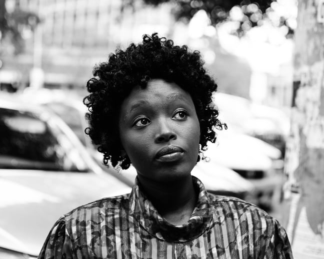 Woman With Curly Hair Looking Up Grayscale Photography